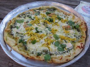 Everyone agrees this crab, tandoori chicken, green sauce, cilantro and hearts of palm-covered crust is still pizza.